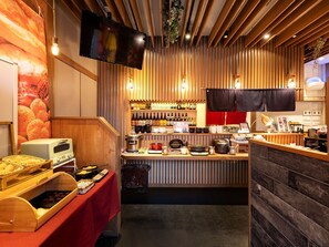A restaurant interior with a wooden counter, a bread display, and a wine rack. - KOKO HOTEL Higashiosaka (Higashi-osaka)