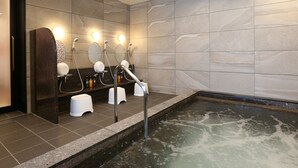A modern bathroom with a large bathtub, multiple sinks, and a mirror. - KOKO HOTEL Higashiosaka (Higashi-osaka)