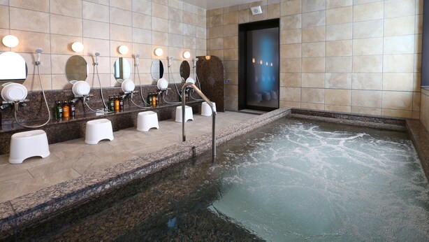 A modern bathroom with multiple sinks, mirrors, and a central hot tub. - KOKO HOTEL Higashiosaka (Higashi-osaka)