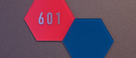 A red hexagonal sign with the number 601 on a textured surface.