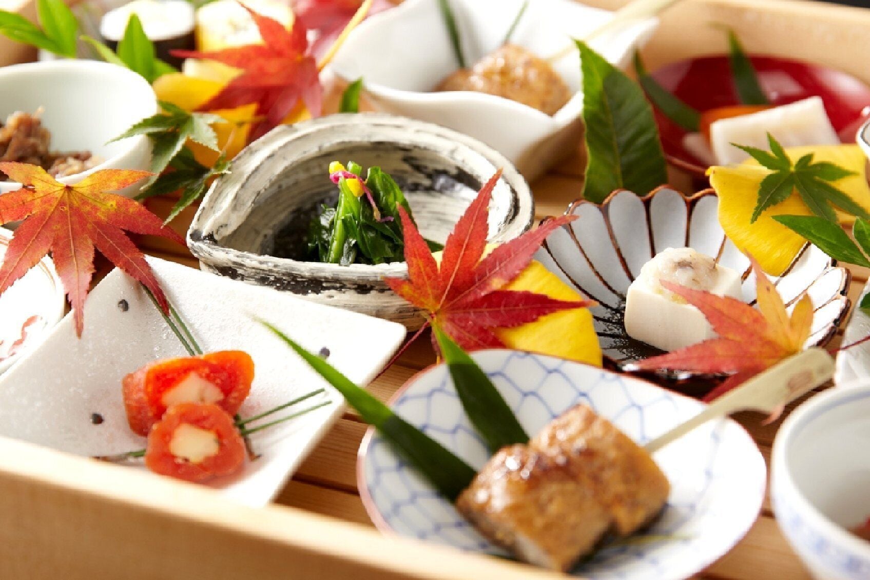 A traditional Japanese meal with various dishes and decorations.