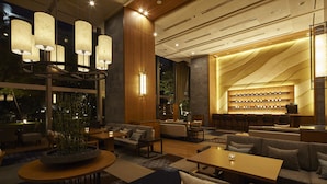 A modern hotel lobby with a seating area, a bar, and a large window. - Takanawa Hanakohro, a Member of Small Luxury Hotels of the World (Tokyo)