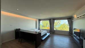A modern hotel room with a bed, desk, and large window. - P168 Hostel Samui (Koh Samui)