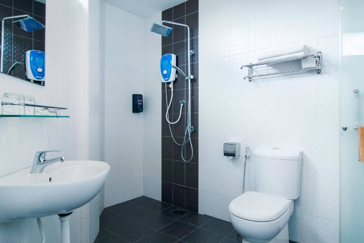 deluxe king bed room  | bathroom | shower, free toiletries, hair dryer, slippers