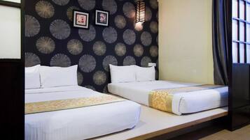 Habitación de hotel con dos camas, una pared de diseño oscuro, una pared de color claro, una ventana con cortinas y una lámpara fijada a la pared.