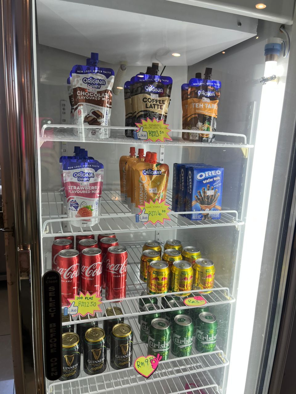 A refrigerated display case with various beverages including milk, coffee, and energy drinks.