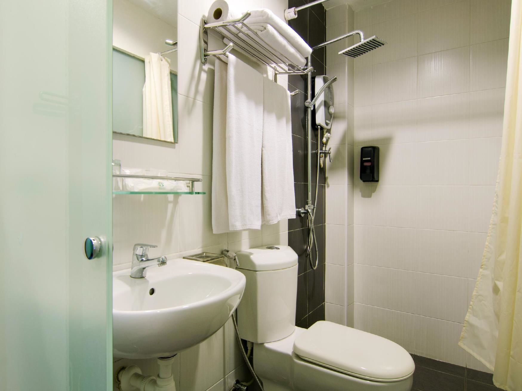 A bathroom with a sink, toilet, and shower.