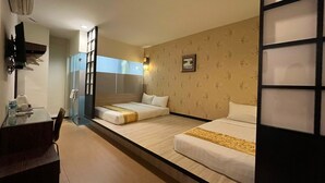 A hotel room with two beds, a desk, and a small table. - Eight Days Boutique Hotel (Johor Bahru)