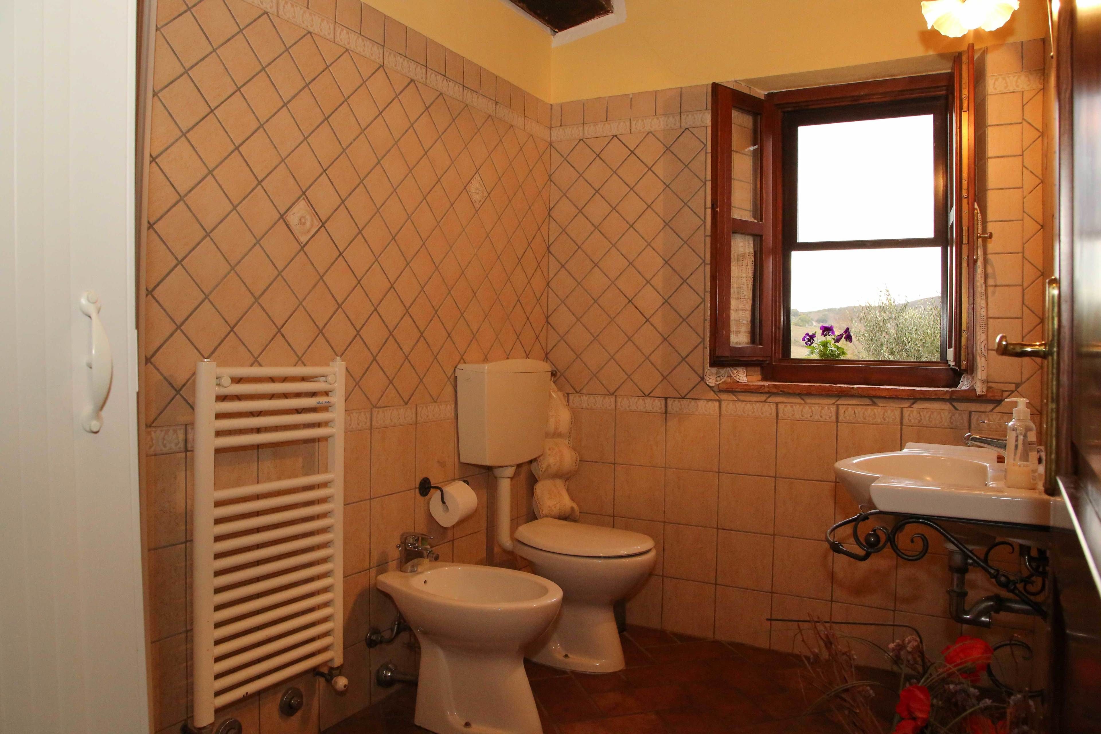 A bathroom with a toilet, bidet, and sink.