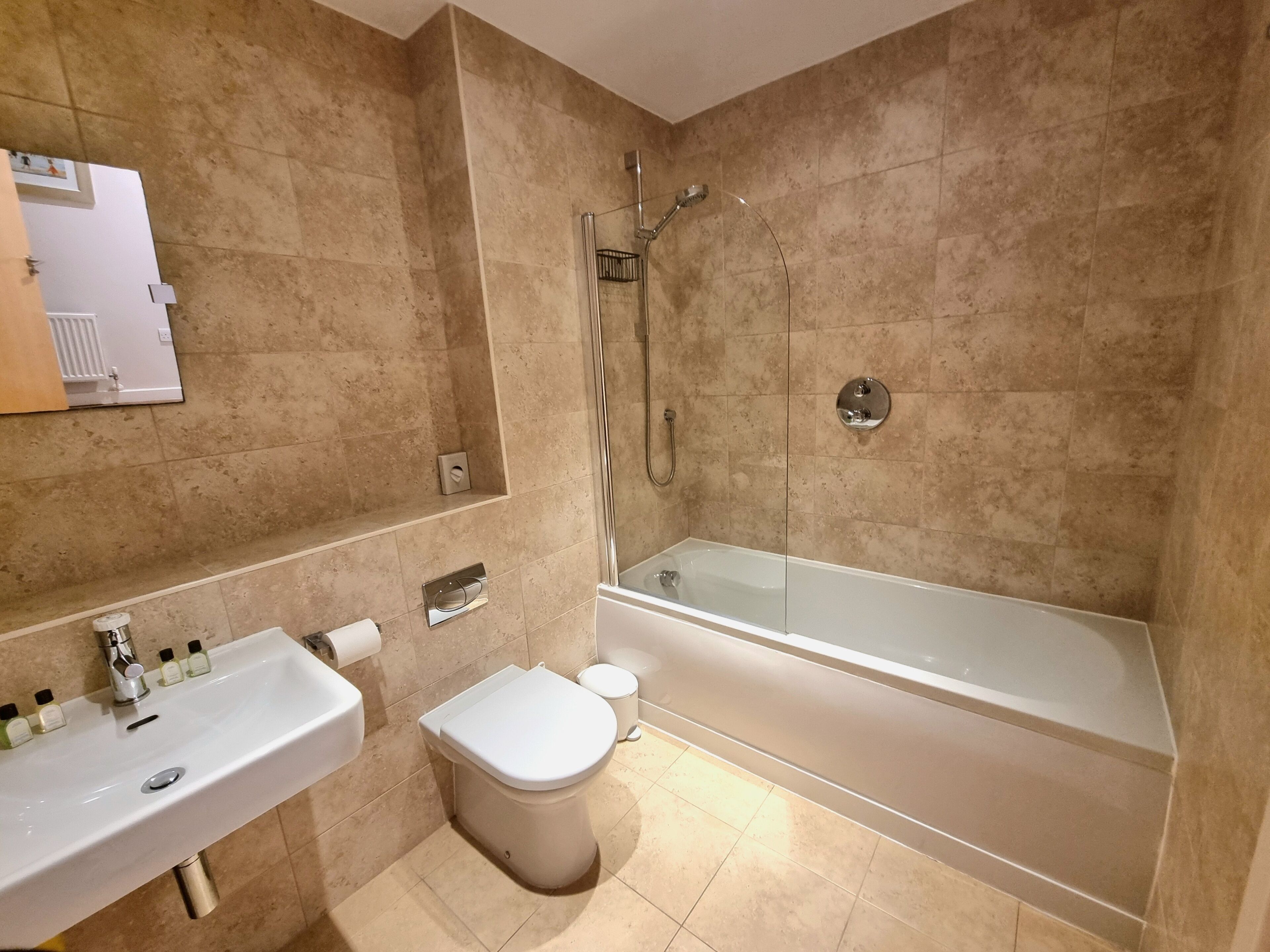 A bathroom with a sink, toilet, and bathtub.