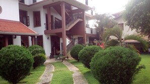 A two-story building with a central staircase, a stone pathway, and well-maintained hedges. - Norfolk Heritage Airport Villa (Seeduwa - Katunayake)