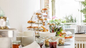 A breakfast buffet with various pastries, bread, and beverages. - Messehotel Köln-Deutz (Cologne)