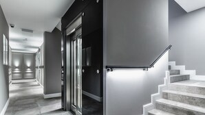 A modern interior with a staircase, a door, and a hallway. - Frapolli 21 (Odesa)