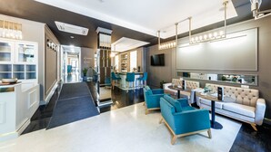 A modern hotel lobby with a central seating area, a bar, and a TV mounted on the wall. - Frapolli 21 (Odesa)