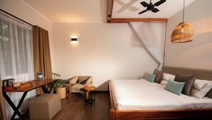 A modern hotel room with a wooden bed, a desk with a chair, a small table, and a ceiling fan. - Aishi Machame Hotel (Moshi)