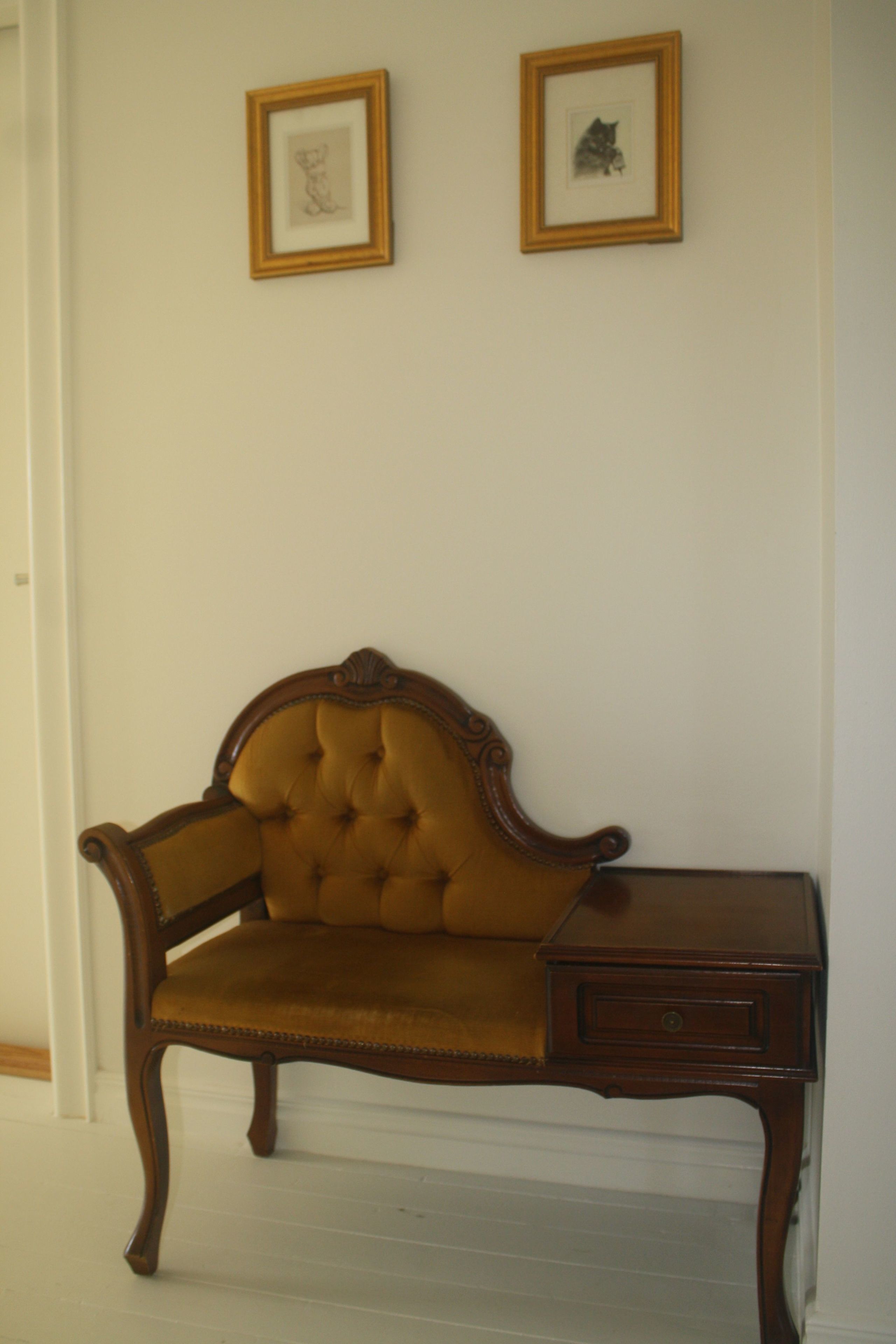 A corner room with a wooden chair and a small wooden table.