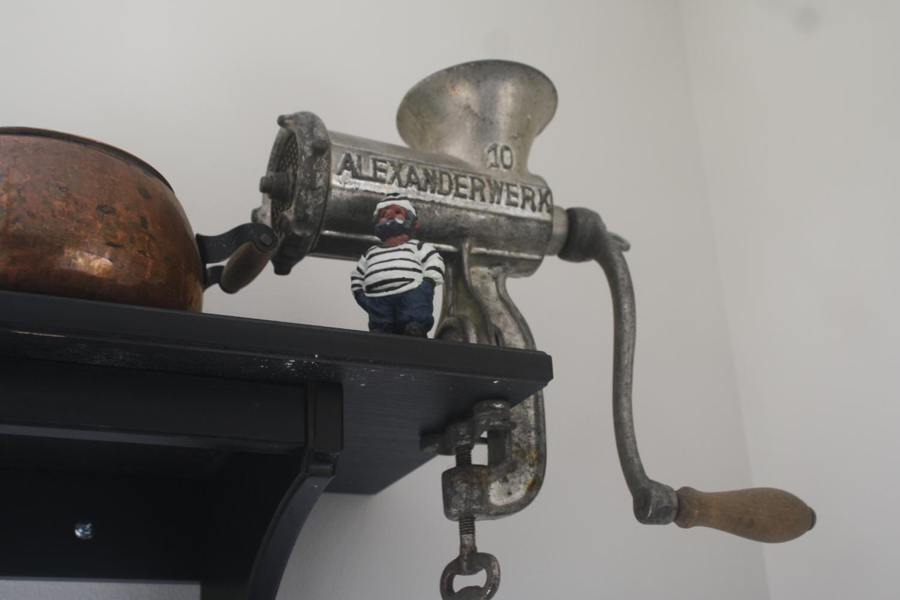 A vintage mechanical device with the brand name "ALEXANDERWERK" and the number "10" on it.