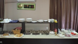 A buffet setup with multiple serving stations, including plates, bowls, and trays of food. - Alma-Ata Hotel (Borjomi)