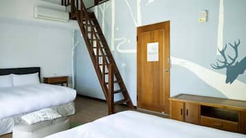 A bedroom with two beds, a wooden wardrobe, a small bedside table, and a wall mural.