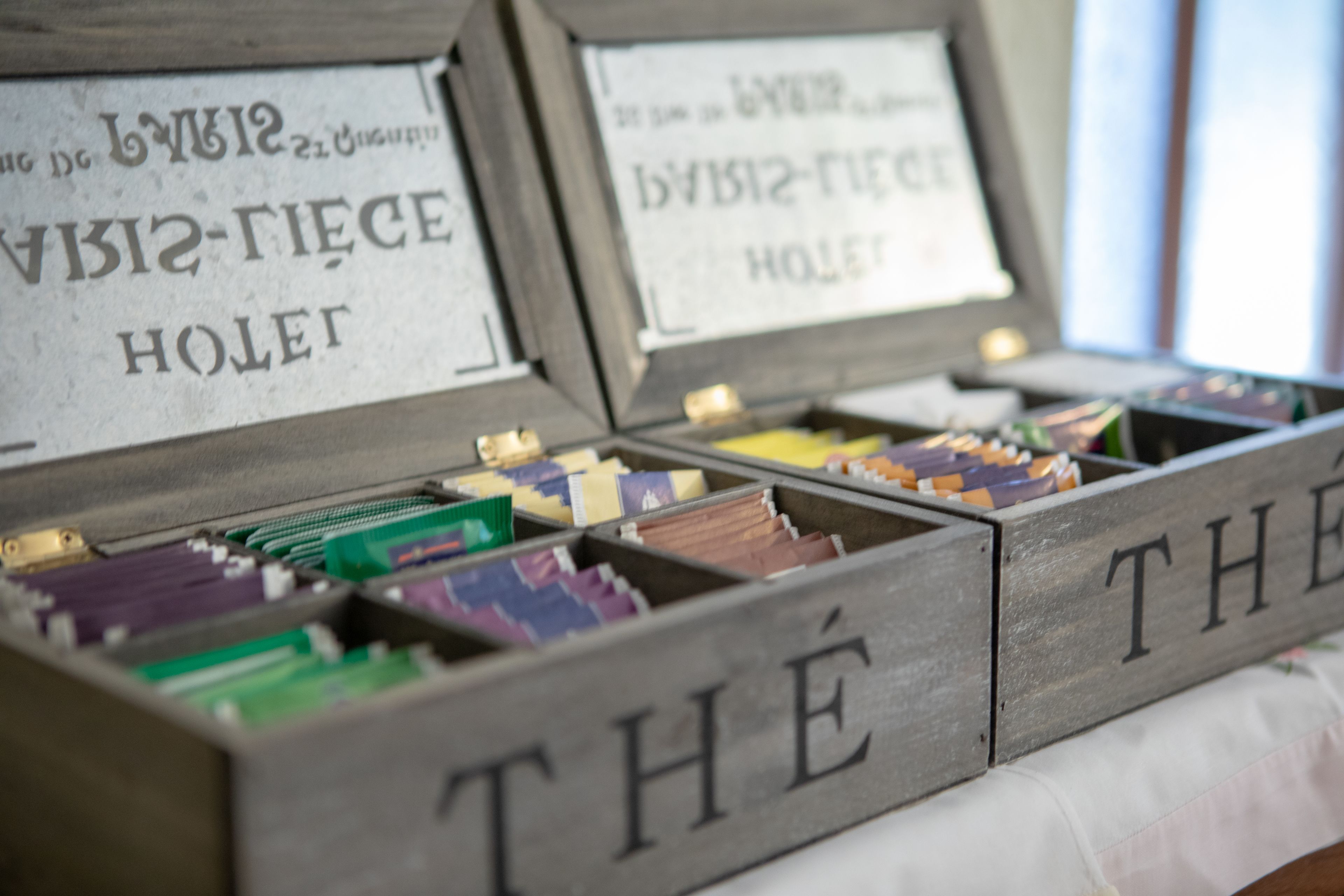 Wooden boxes labeled with names, containing various colored envelopes.