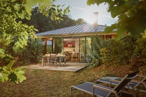 Enjoy meals in the conservatory, adjacent to the kitchen, surrounded by lush greenery.