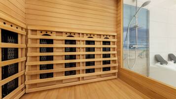 Relax in a sauna with a glass-enclosed shower and bathtub.