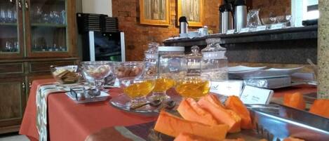 A buffet table with various food items and condiments.