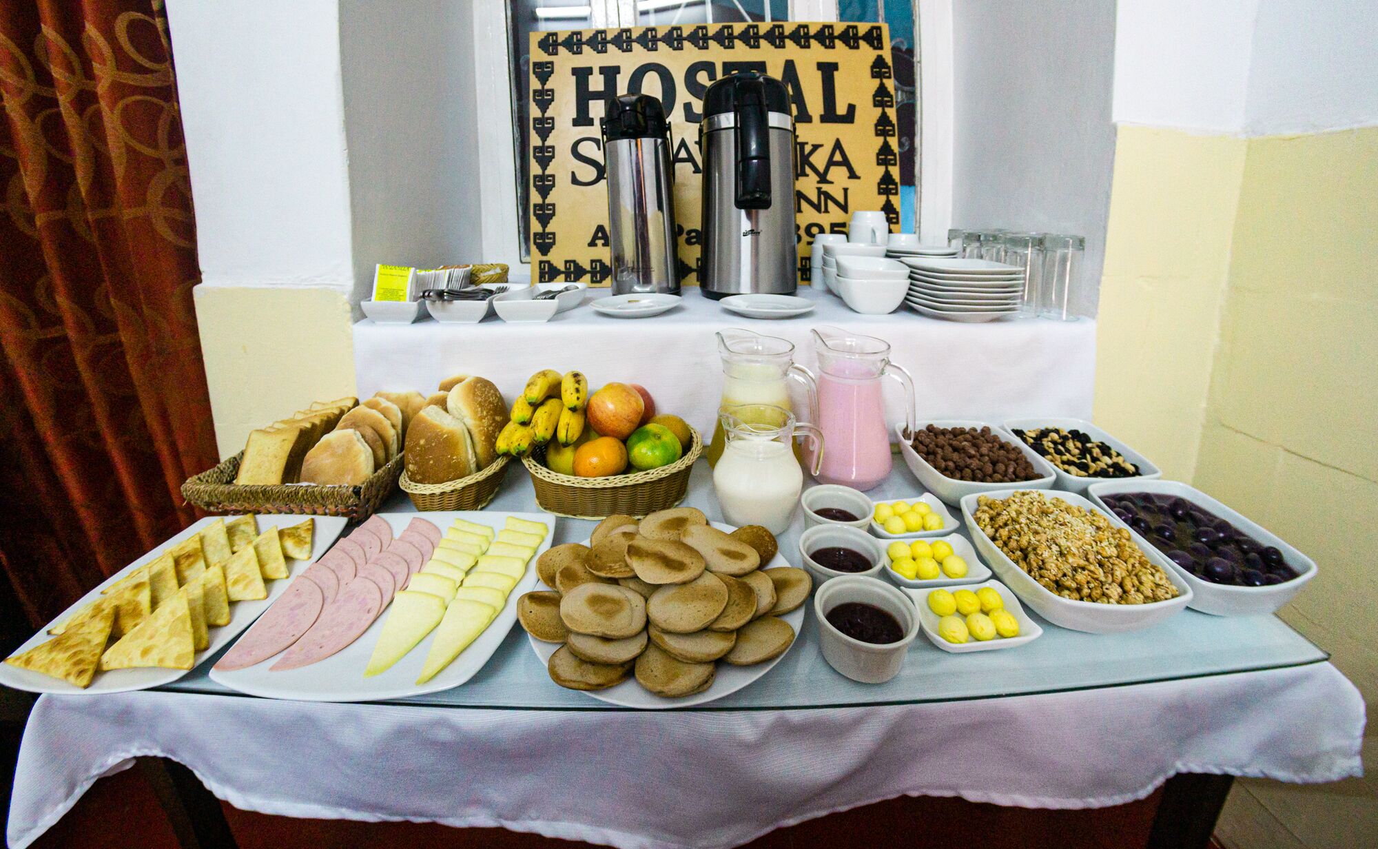 A breakfast buffet with various food items and beverages.