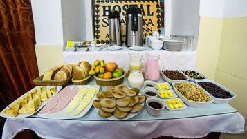A breakfast buffet with various food items and beverages.