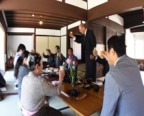 A traditional Japanese room with tatami flooring, a low table, and a wooden ceiling. - Tarao no Ie (Koka)
