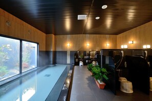 A modern bathroom with wooden paneling, a glass shower enclosure, and a view of the outdoors. - Hotel Route-Inn Yanagawa Ekimae (Yanagawa)