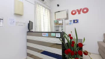 A reception area with a counter, a sign for free Wi-Fi, and a 'Book Us' sign.
