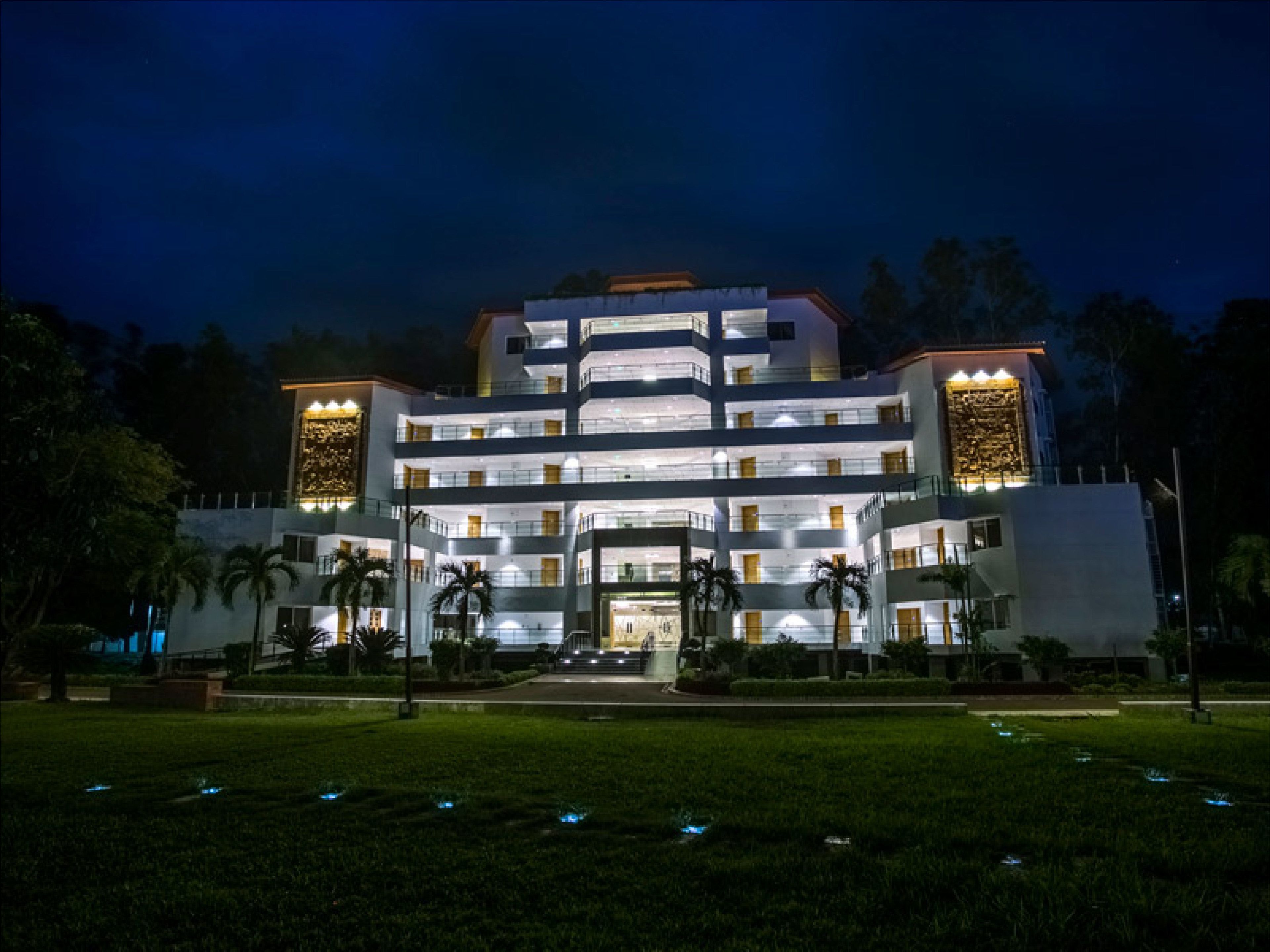 A multi-story hotel with a central courtyard, featuring a symmetrical facade with evenly spaced windows and balconies.