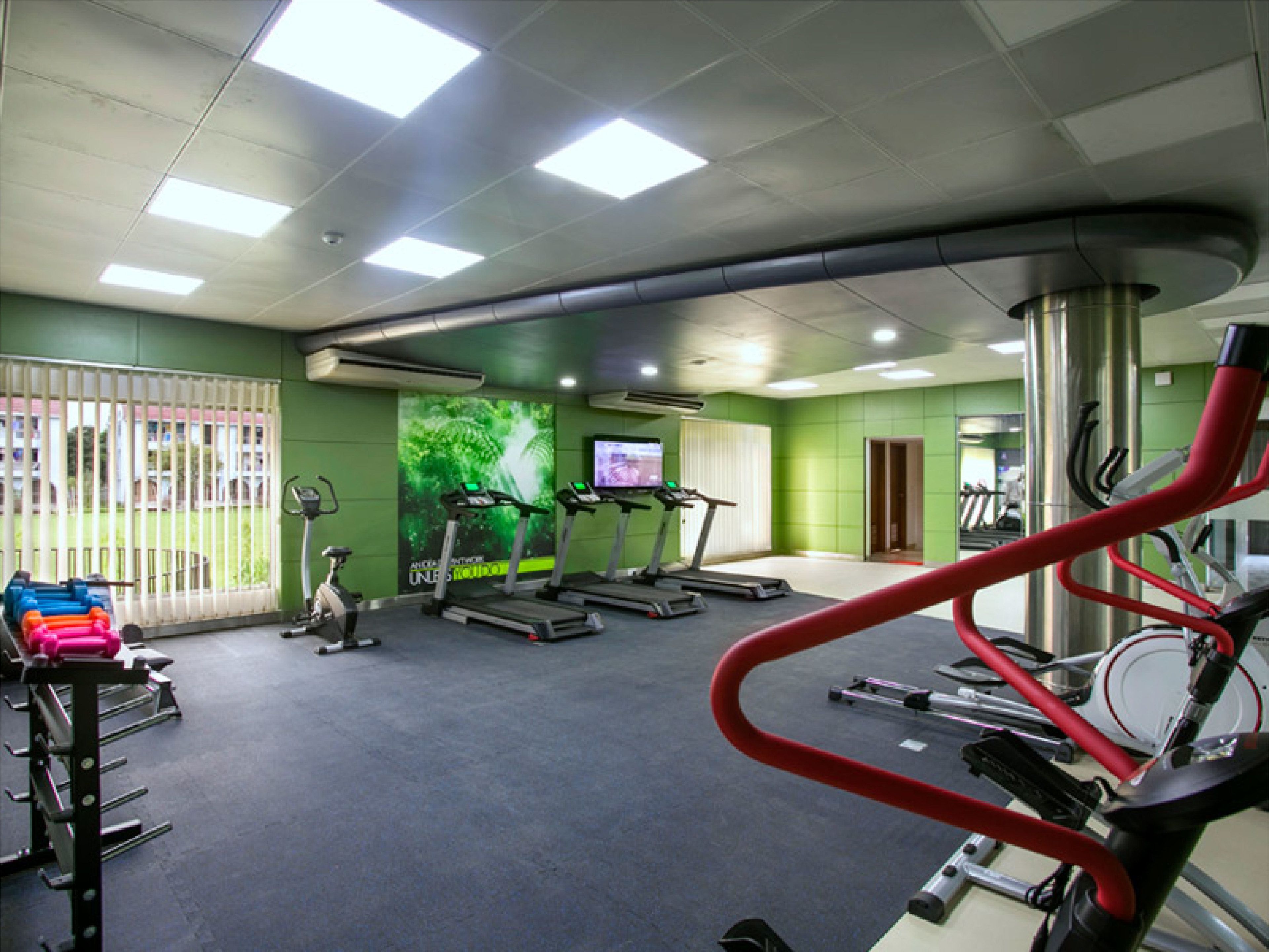 A gym with treadmills, stationary bikes, and weight machines.