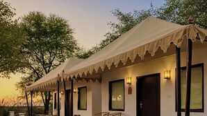 A two-story building with a checkered floor plan, outdoor seating, and a covered porch. - Achrol Niwas A TreeHouse Hotel (Amer)