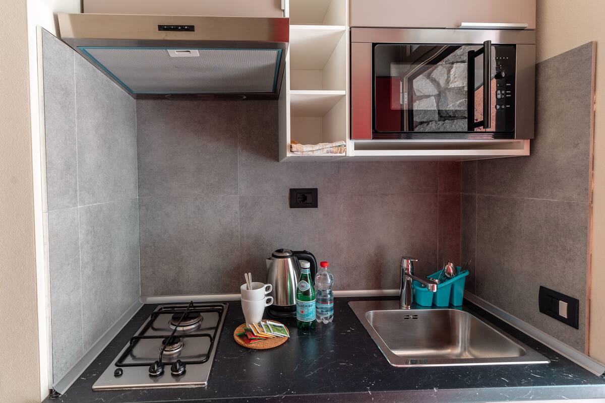 bungalow, 1 bedroom, patio, ground floor | private kitchen | fridge, coffee/tea maker, electric kettle, high chair