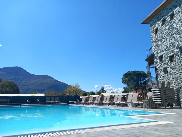 Seasonal outdoor pool, open 8:00 AM to 8:00 PM, pool umbrellas