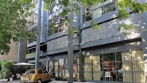 A multi-story building with a car parked in front. - Collection O The Spades Hostel (Bangkok)
