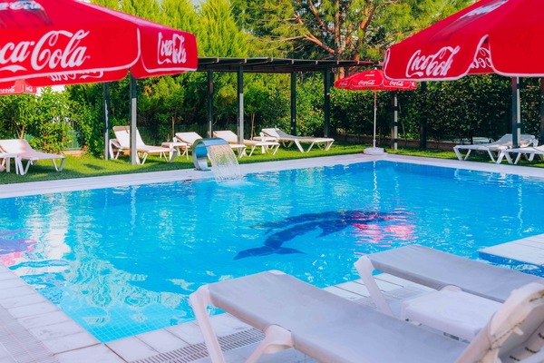 Outdoor pool, a waterfall pool, pool umbrellas, sun loungers