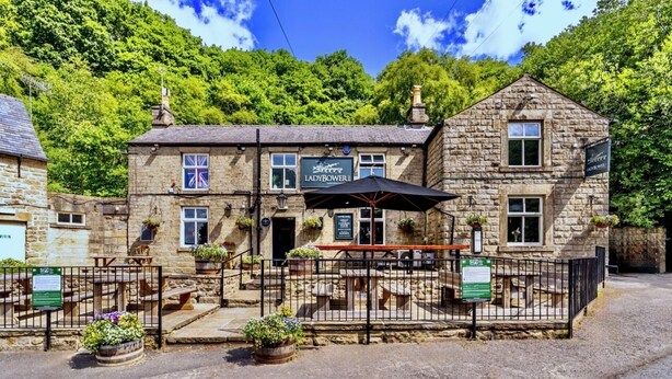 A stone building with a sign reading "Lady Bower." - Ladybower Inn (Hope Valley)