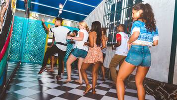 Una pista de baile con un diseño de cuadros, rodeada por una pared azul y blanca con un enrejado.