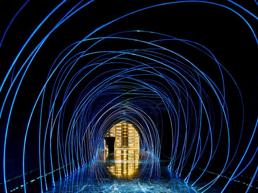 A tunnel-like structure with light trails leading to a central illuminated area.