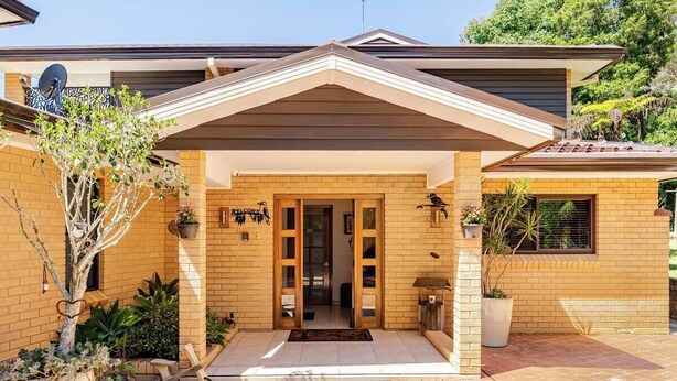 A modern house with a brick exterior, a covered porch, and a welcoming entrance. - Kookaburra Retreat (Berowra Heights)