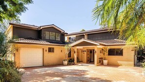 A two-story house with a garage, a covered patio, and a small garden area. - Kookaburra Retreat (Berowra Heights)