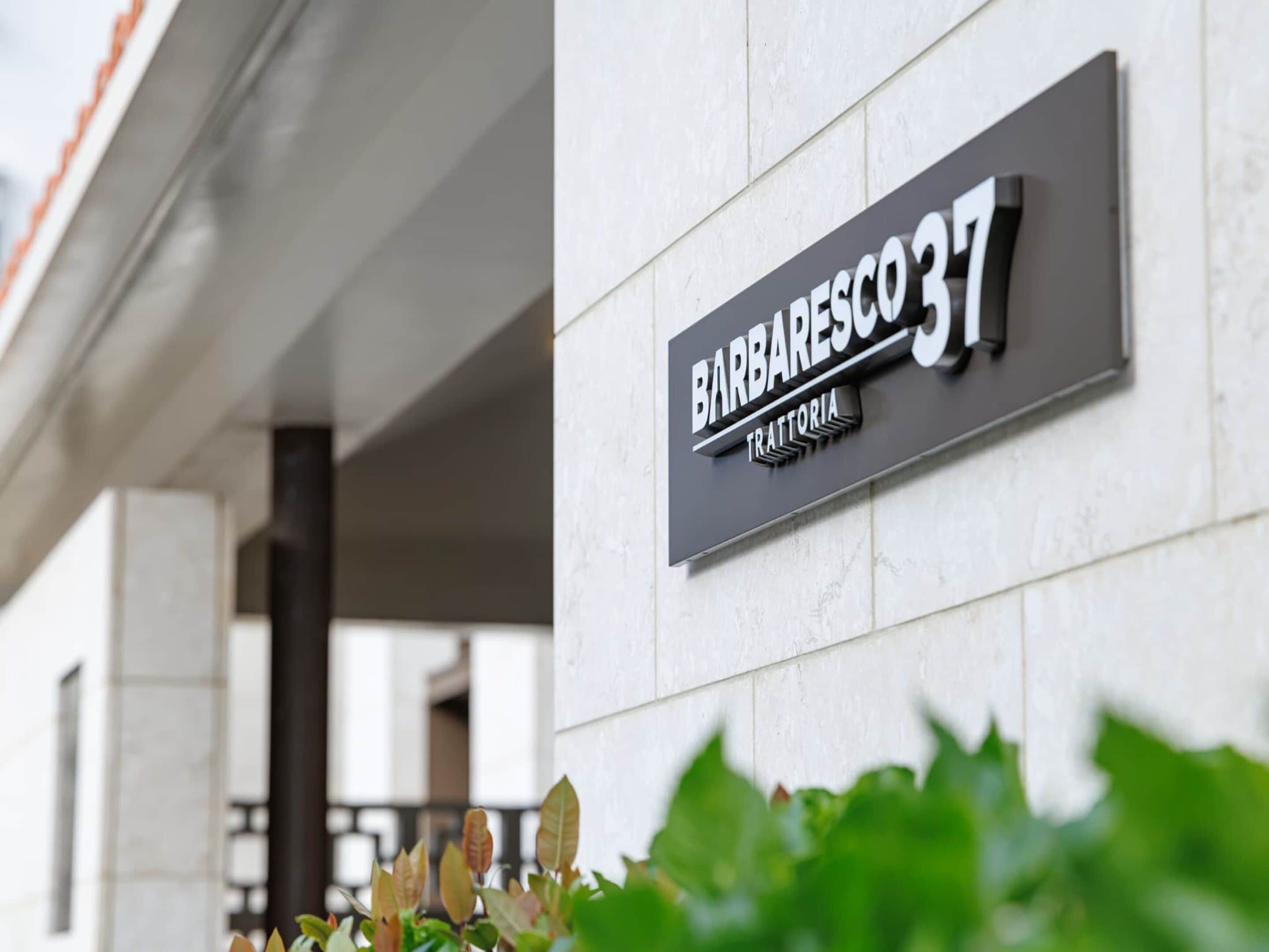 A sign for "Barbarea 37" with a modern design, mounted on a building facade.