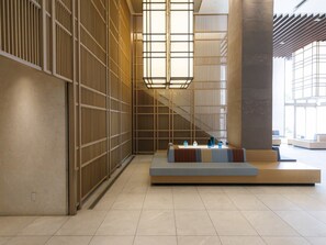 A modern interior with a seating area, a staircase, and a large window. - JR KYUSHU HOTEL Blossom Naha (Naha)