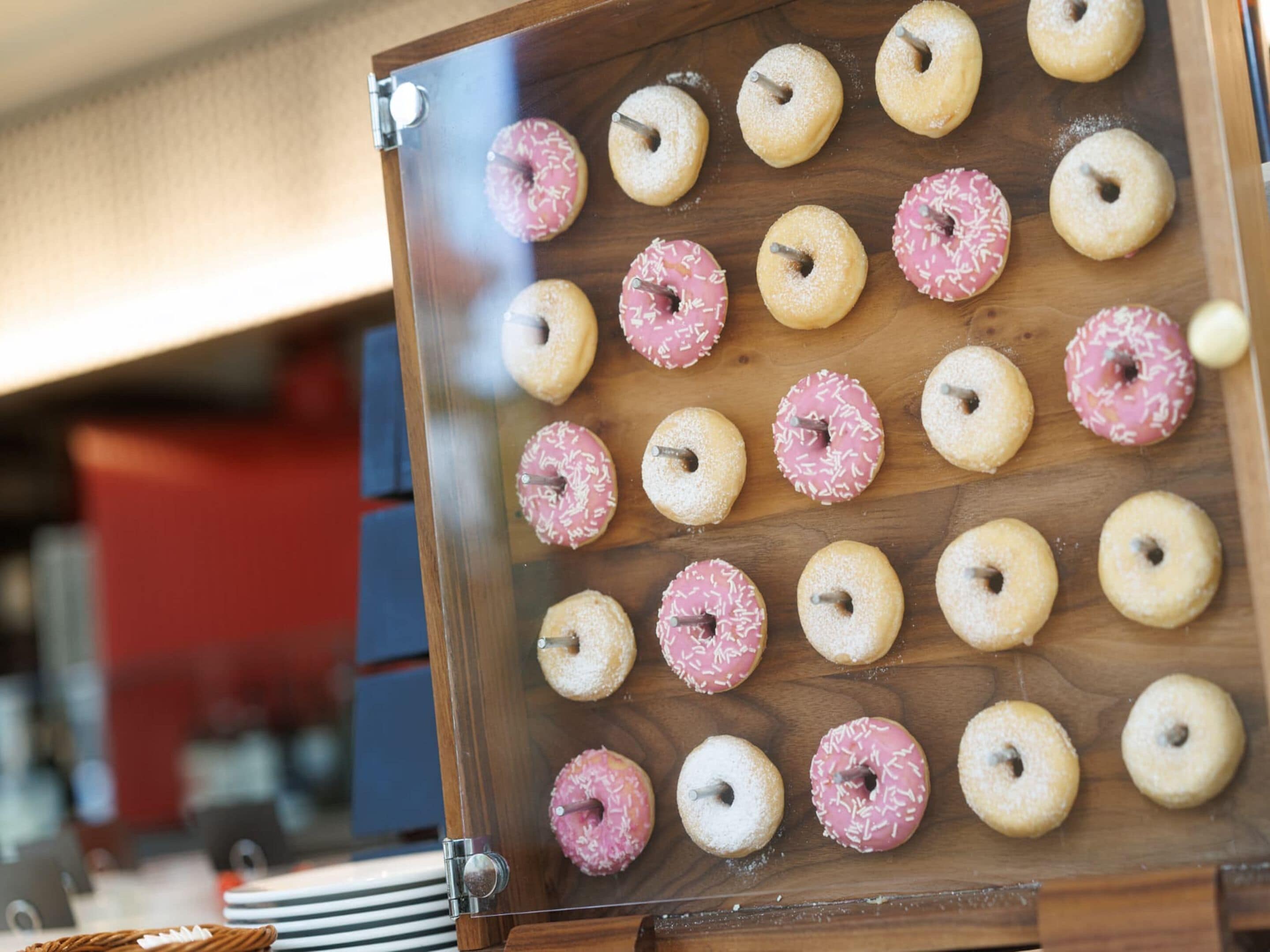 A display of assorted donuts on a wooden board.
