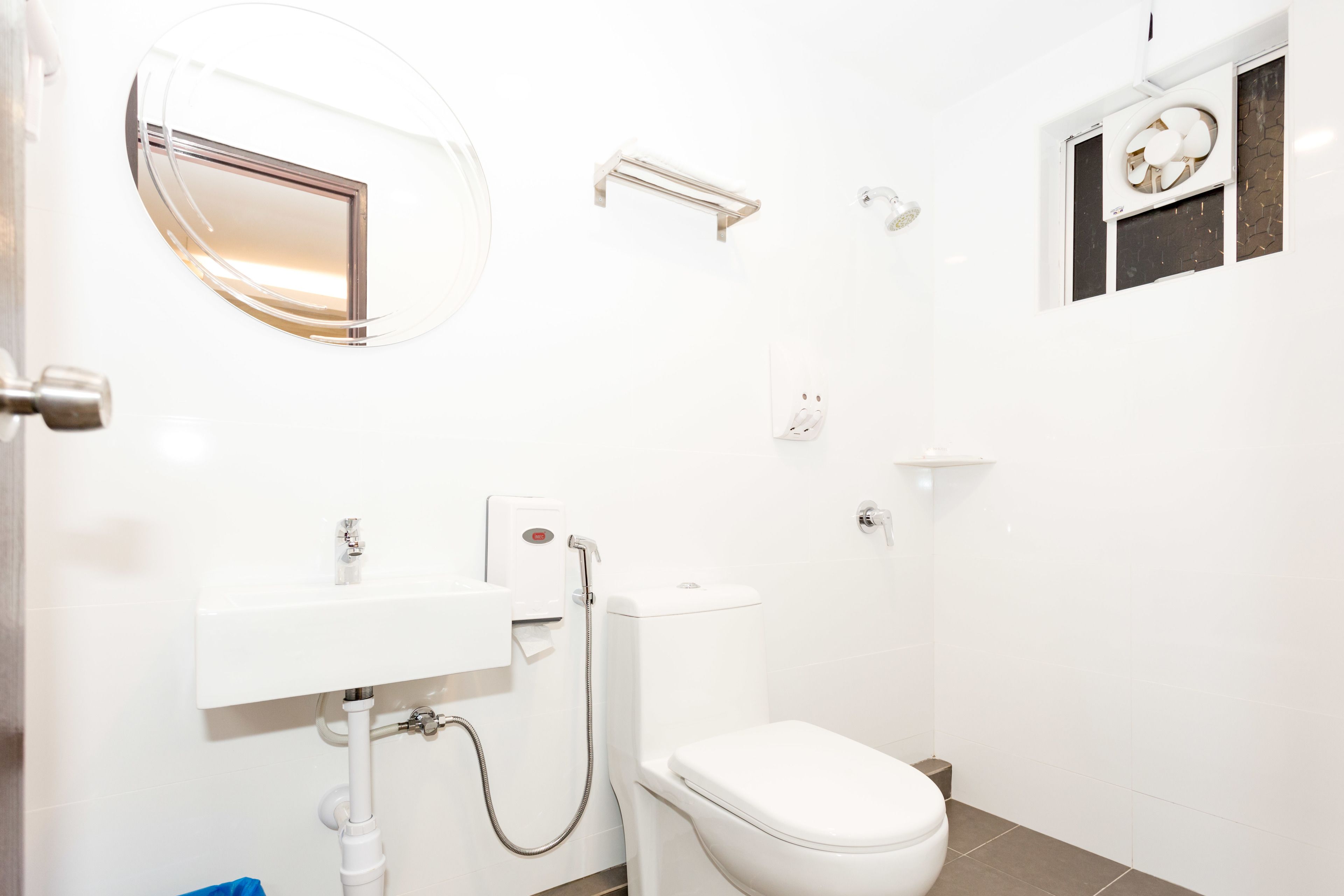A modern bathroom with a toilet, sink, and shower.