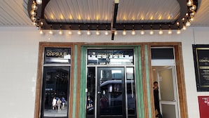 The entrance to The Century Bar with a VIP Lounge sign. - The Capsule Hotel - Hostel (Haymarket)