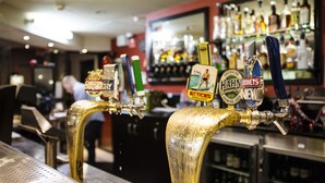 A bar with multiple beer taps, each labeled with different beer brands. - Nightcap at Hume Hotel (Yagoona)